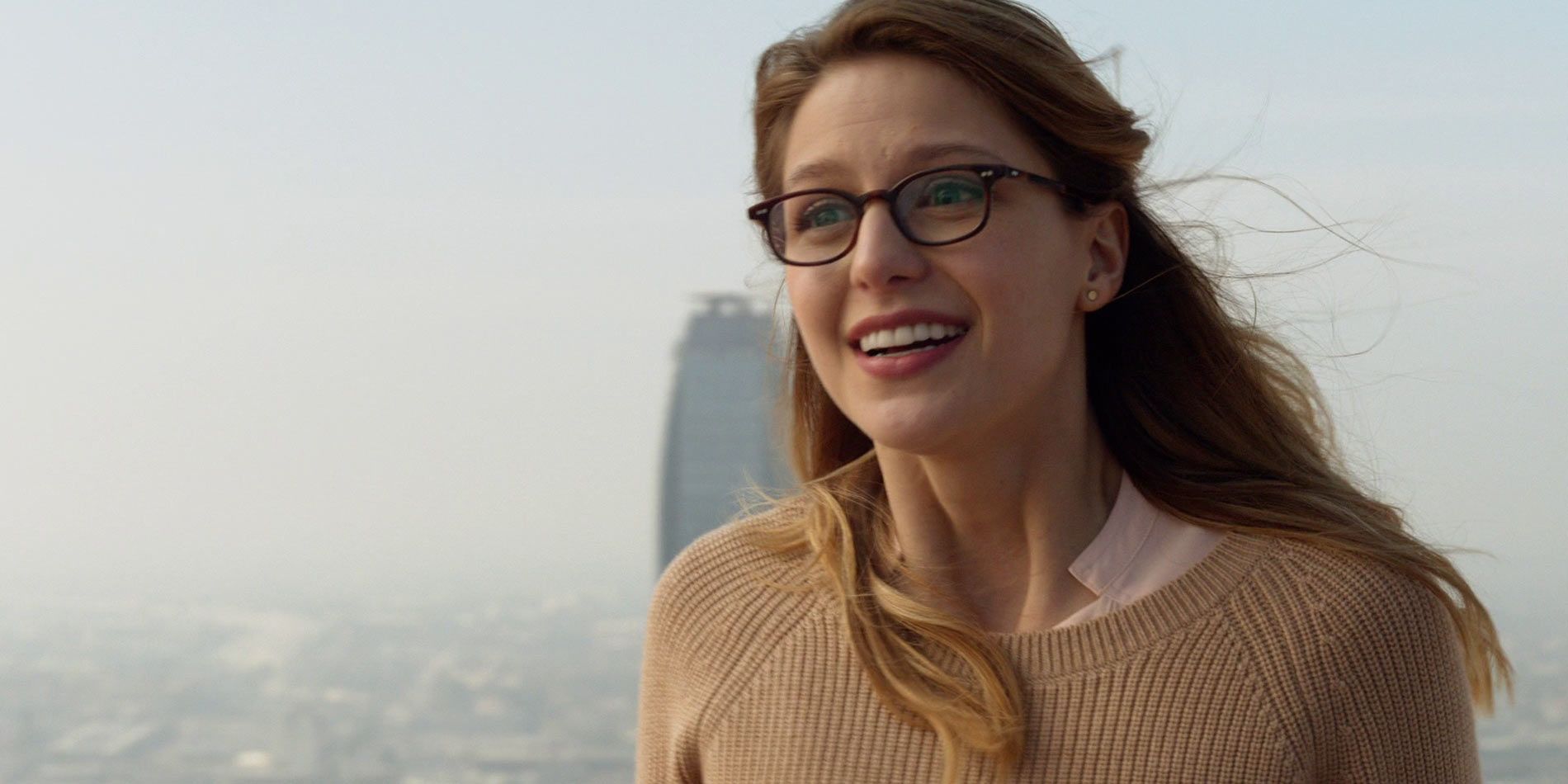 Kara Danvers with National City in the background in Supergirl