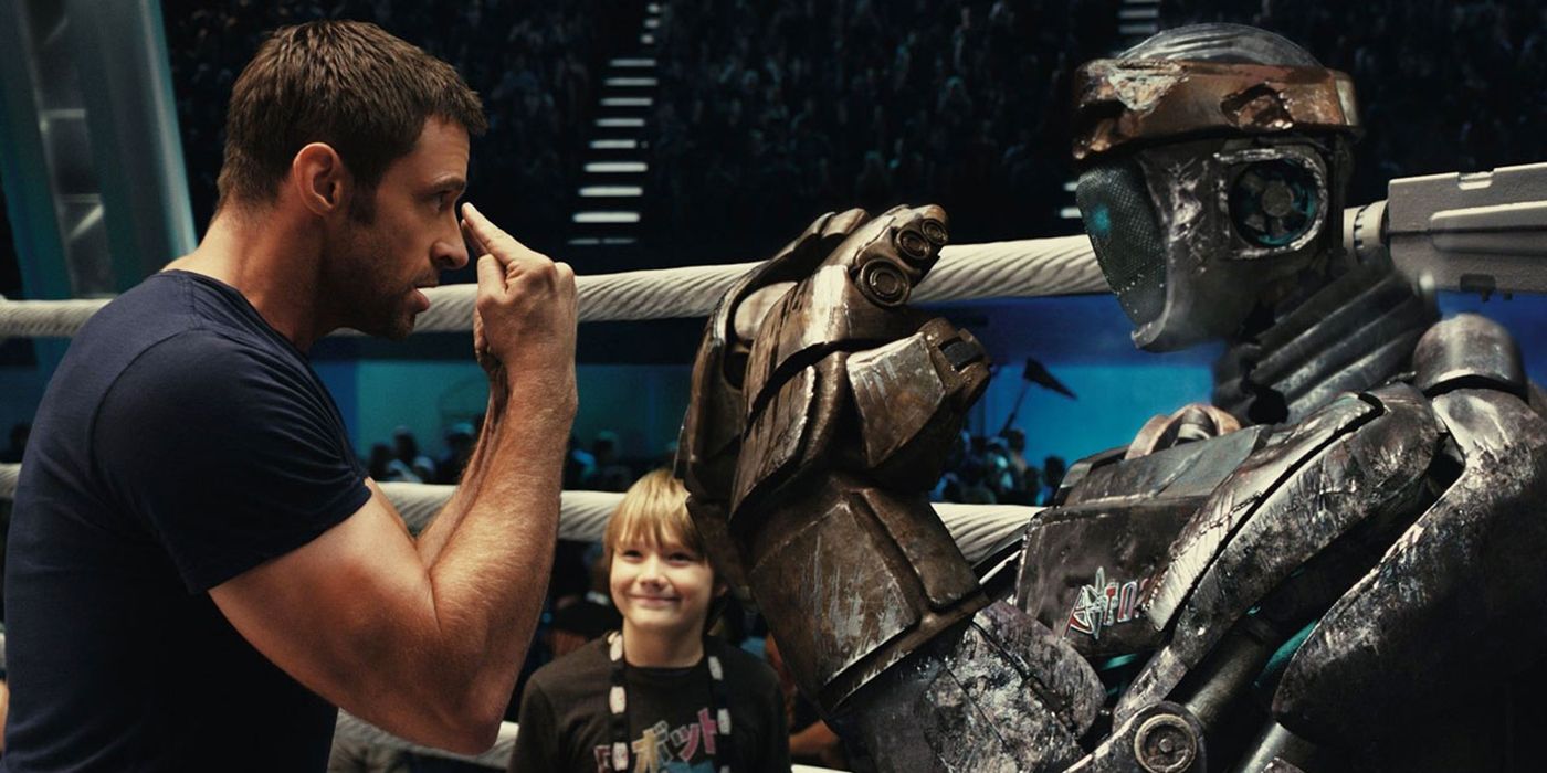 Hugh Jackman in Real Steel in a boxing ring talking to the robot, Atom