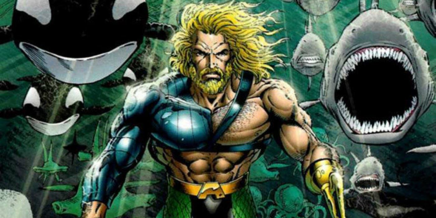 A bearded Aquaman is surrounded by sea life while underwater