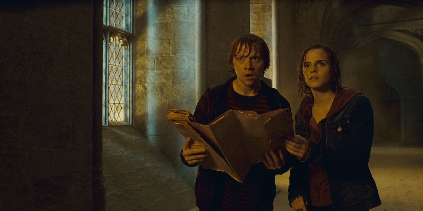 Ron and Hermione walk along a Hogwarts corridor with the Marauder's Map