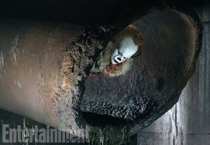 Pennywise the Clown plays a deadly game of peek-a-boo in a new photo from the It remake.