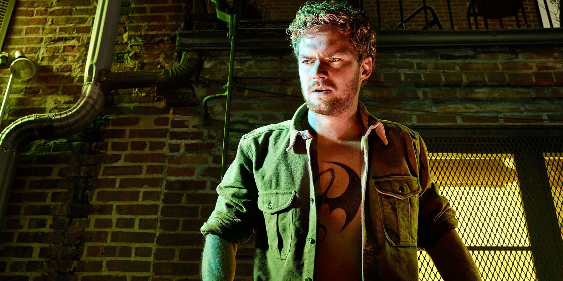 Danny Rand from the Iron Fist series stands outside his building.