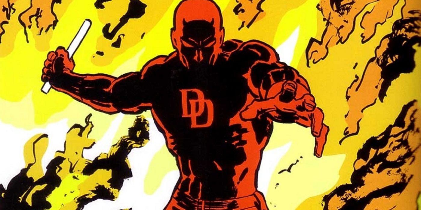 Daredevil holding his billy club as he emerges from the flames.