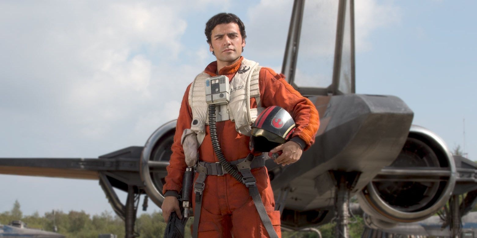 poe dameron in his flight suit holding his helmet in star wars the force awakens