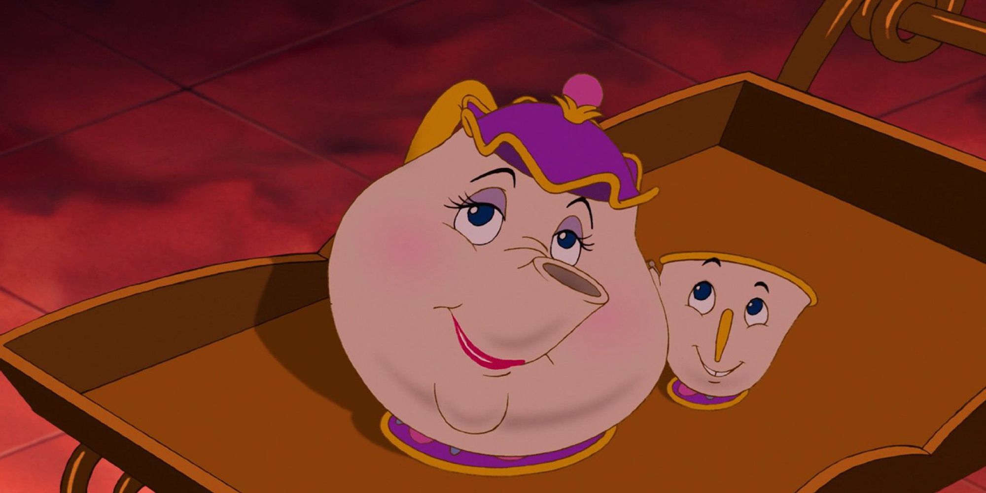 Mrs. Potts, voiced by Angela Lansbury, sits on a tea service with her son Chip in Beauty and the Beast