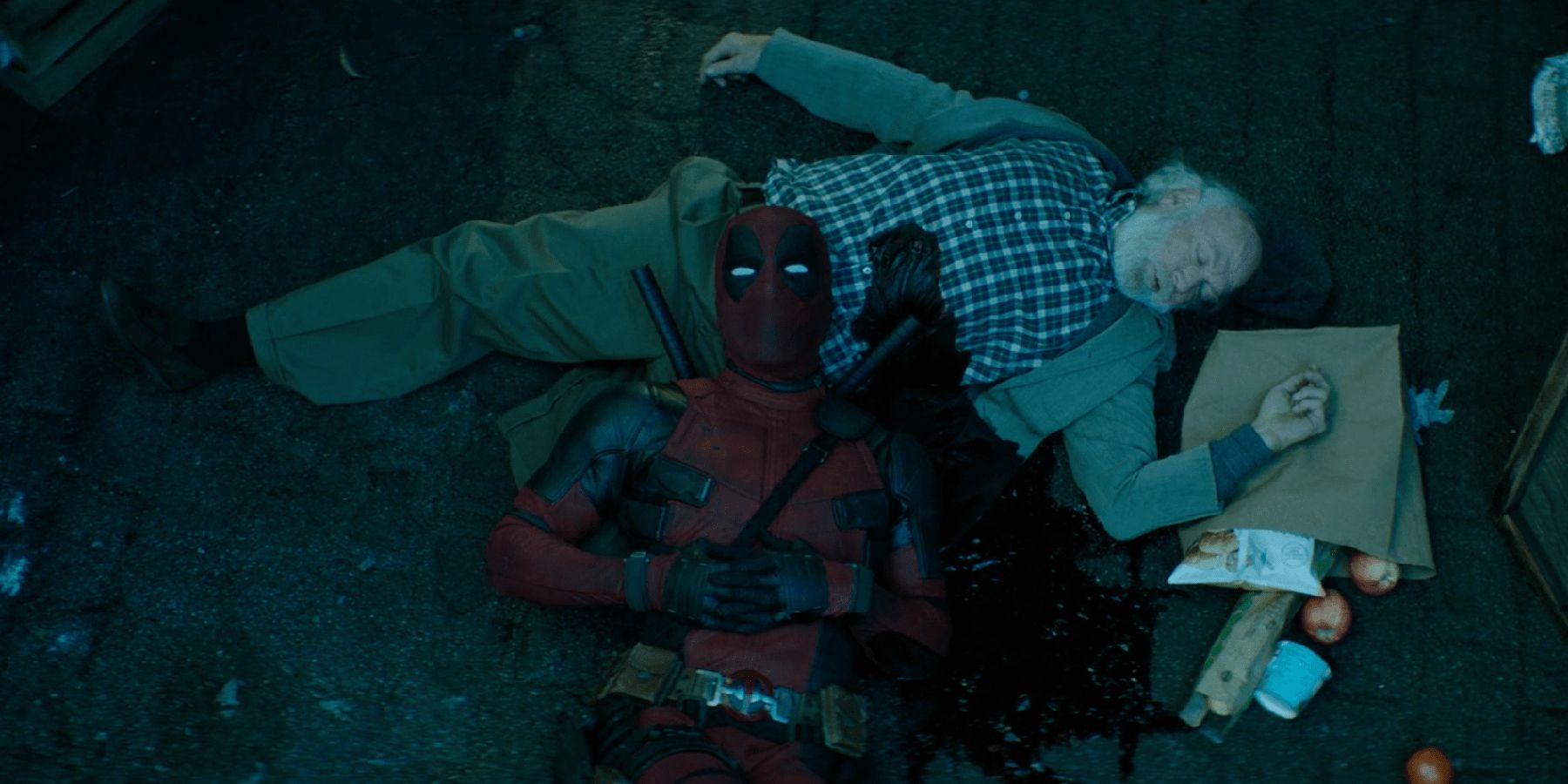 Deadpool resting against a corpse