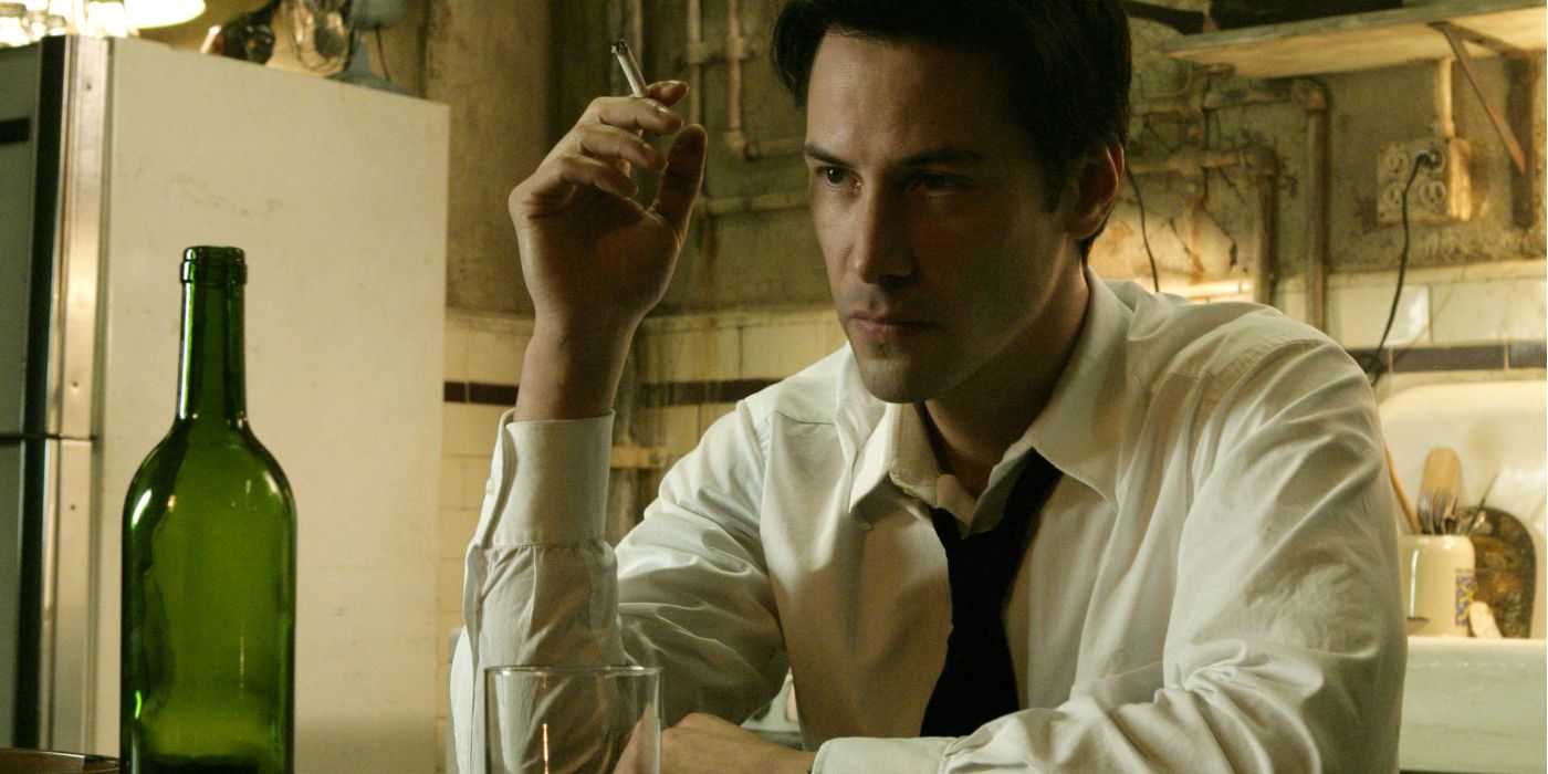 Keanu Reeves' Constantine smokes a cigarette with a bottle of alcohol in front of him