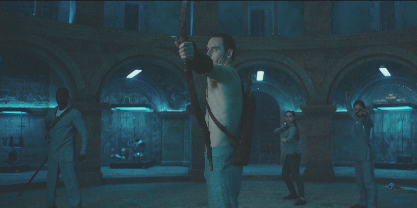 Michael Fassbender drawing a bow and arrow in Assassin's Creed
