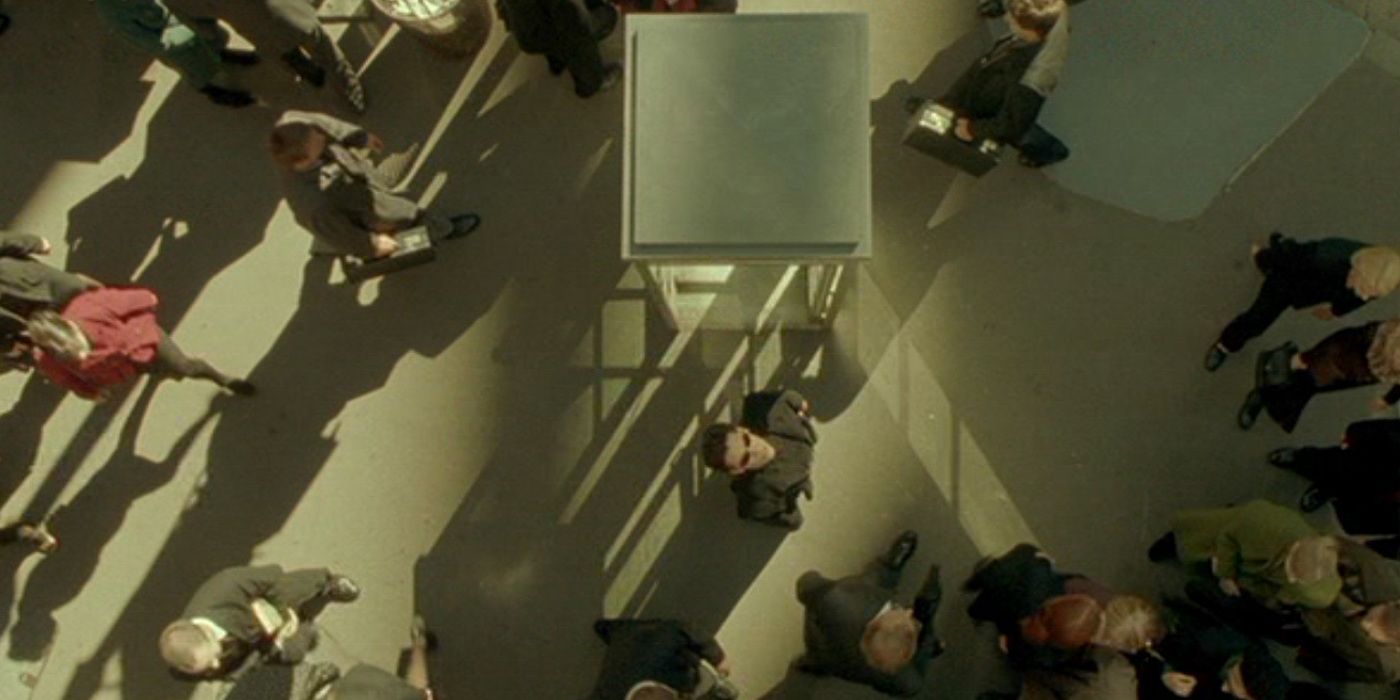 Neo looking up in a crowd at the end of The Matrix