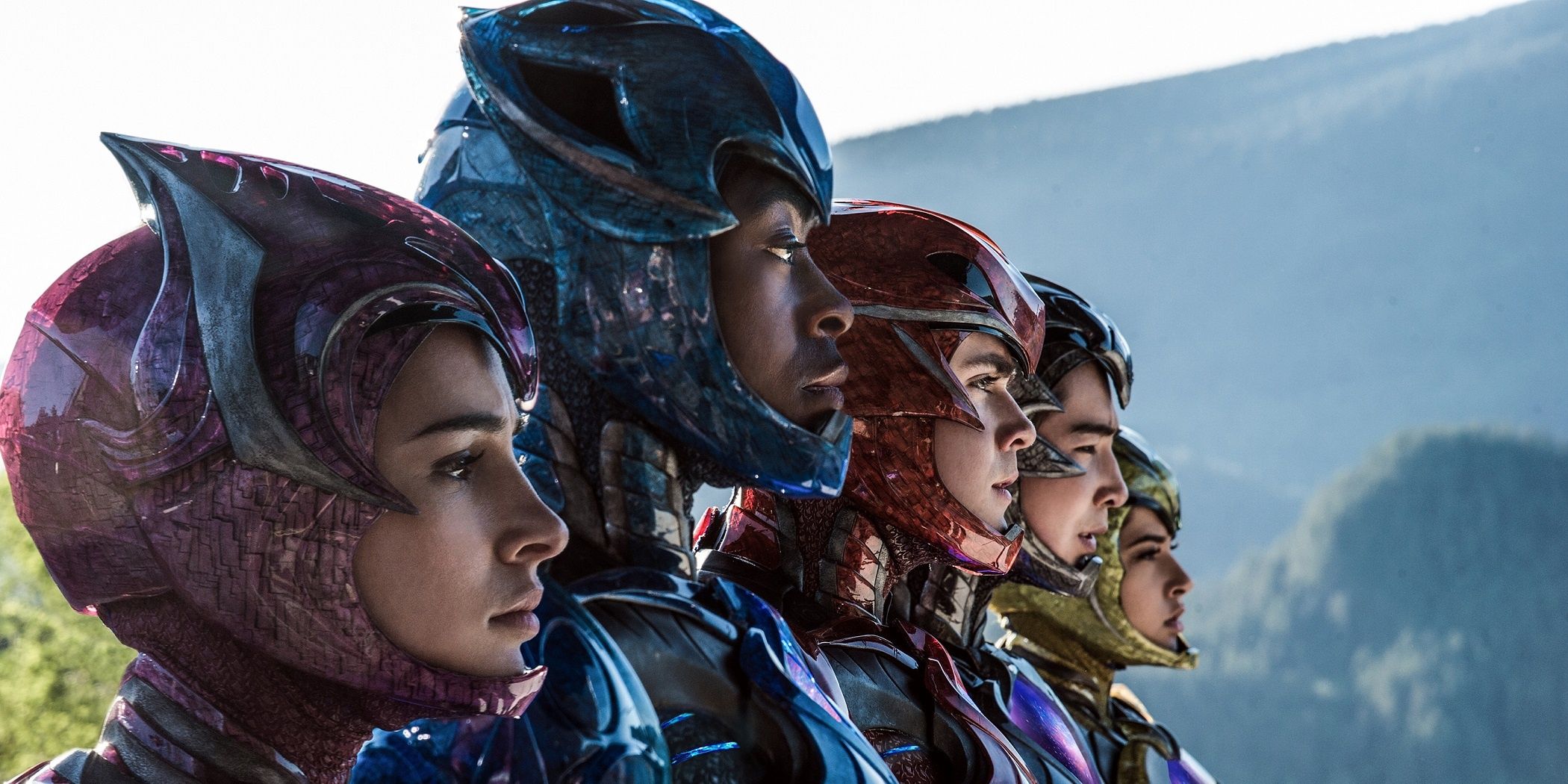 2017 Power Rangers standing in suites with helmet visors open