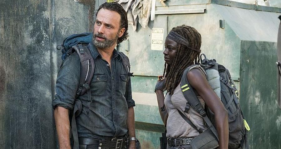 Rick and Michonne from The Walking Dead with backpacks.