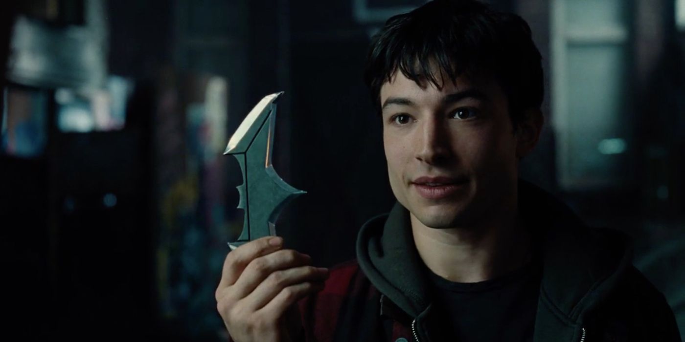 Barry Allen holding a batarang in Justice League