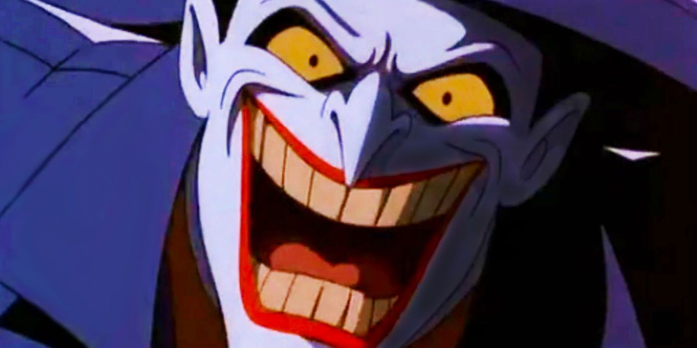 The Joker laughs menacingly at his victim