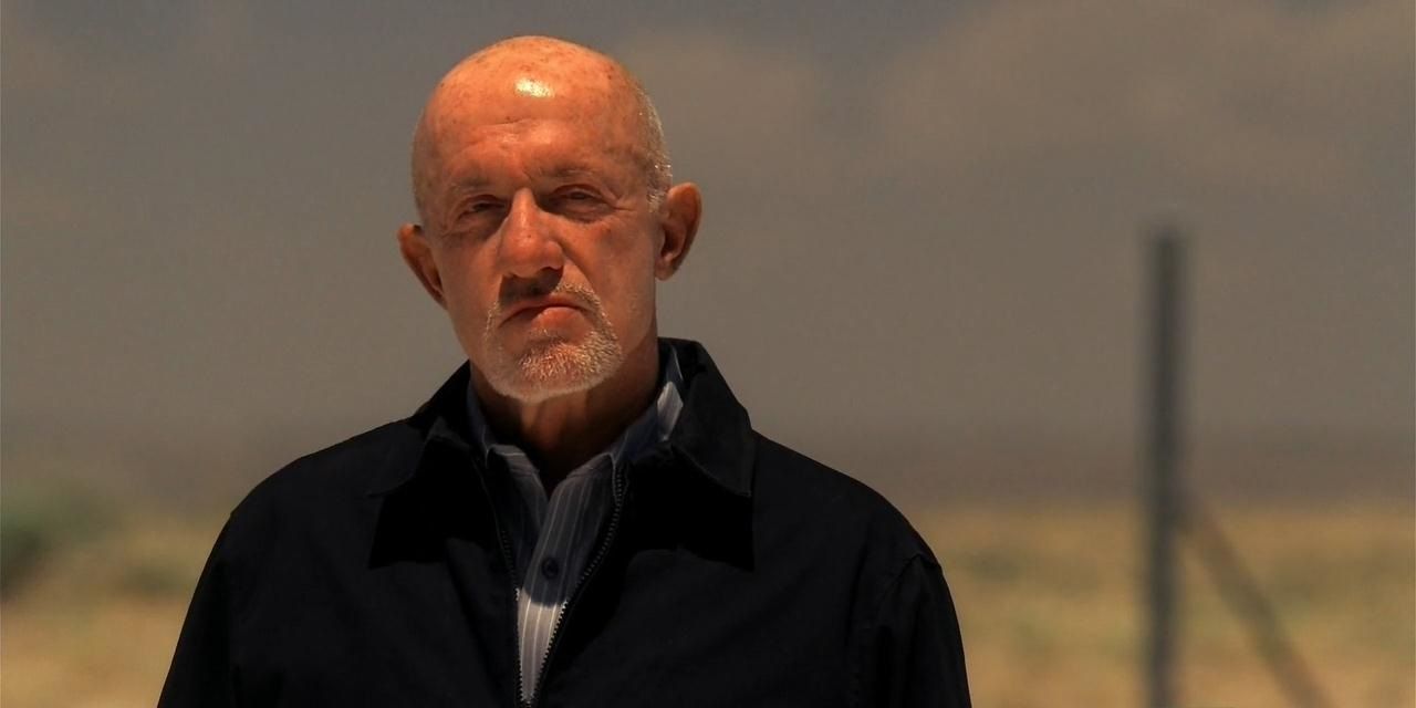 Breaking Bad's Mike Ehrmantraut standing in the desert squinting against the sun.
