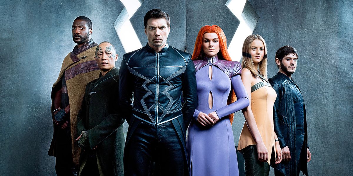 The cast for Inhumans pose in front of Black Bolt's logo.