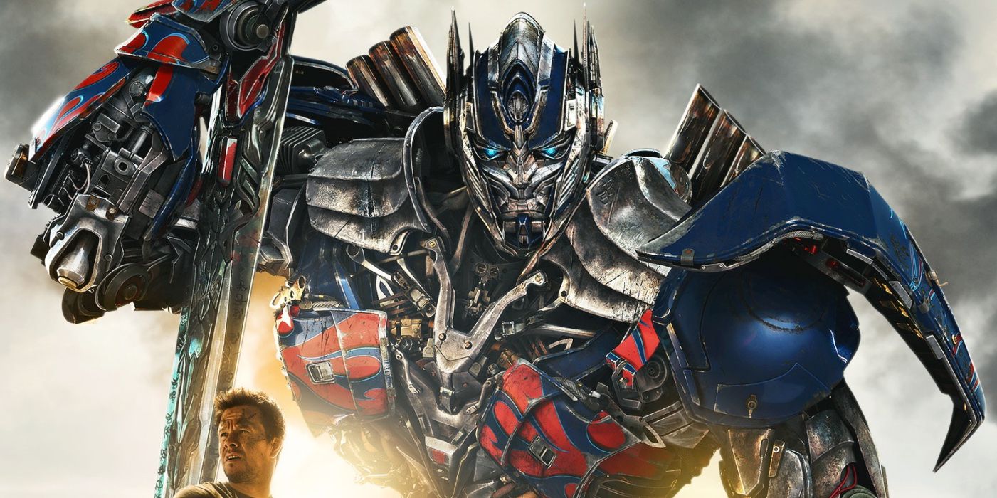 Mark Wahlberg standing in front of Optimus Prime 