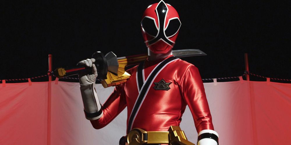 The red ranger of the Samurai Sentai Shinkenger team holding his sword in his elbow