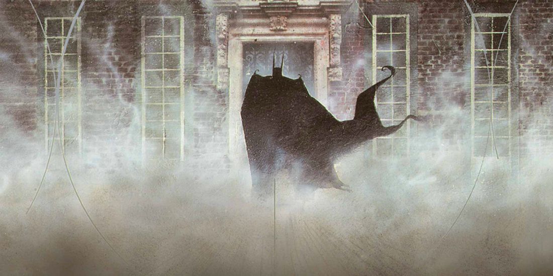 Batman facing Arkham Asylum surrounded by fog in DC Comics