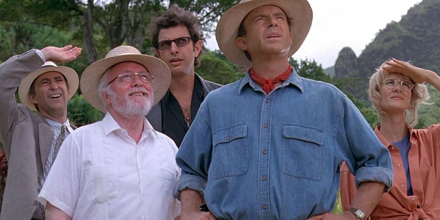 An image of the Jurassic Park cast looking up at something in the distance