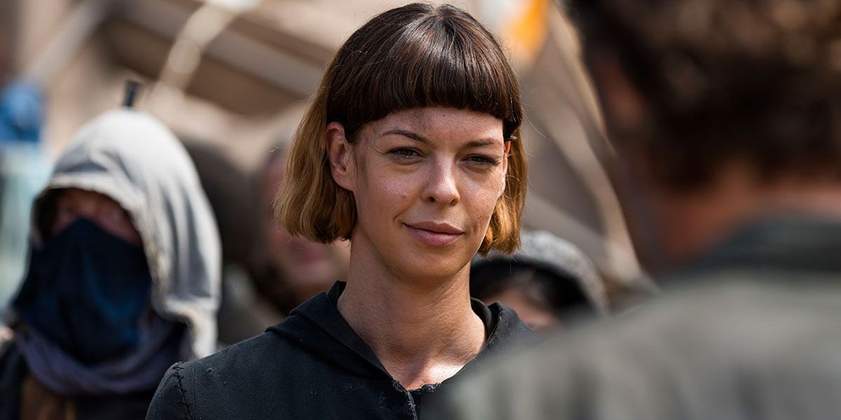 Jadis from The Walking Dead smirking while talking to Rick in the foreground.