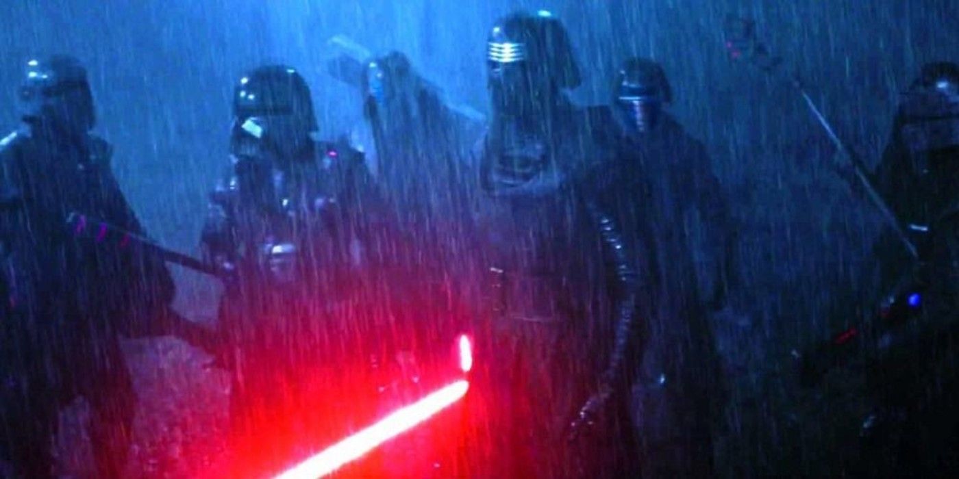 Kylo Ren holds his lightsaber surrounded by the Knights of Ren in Star Wars The Force Awakens.