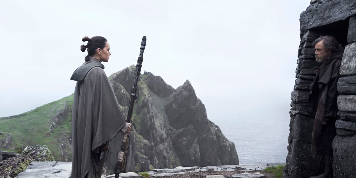 Rey standing outside of Luke's hut on Ahch-To in Star Wars: The Last Jedi