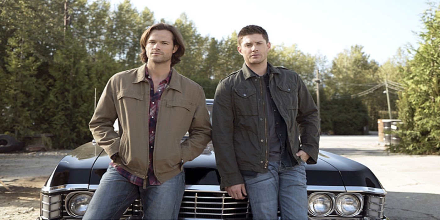 Sam and Dean lean on their car in Supernatural