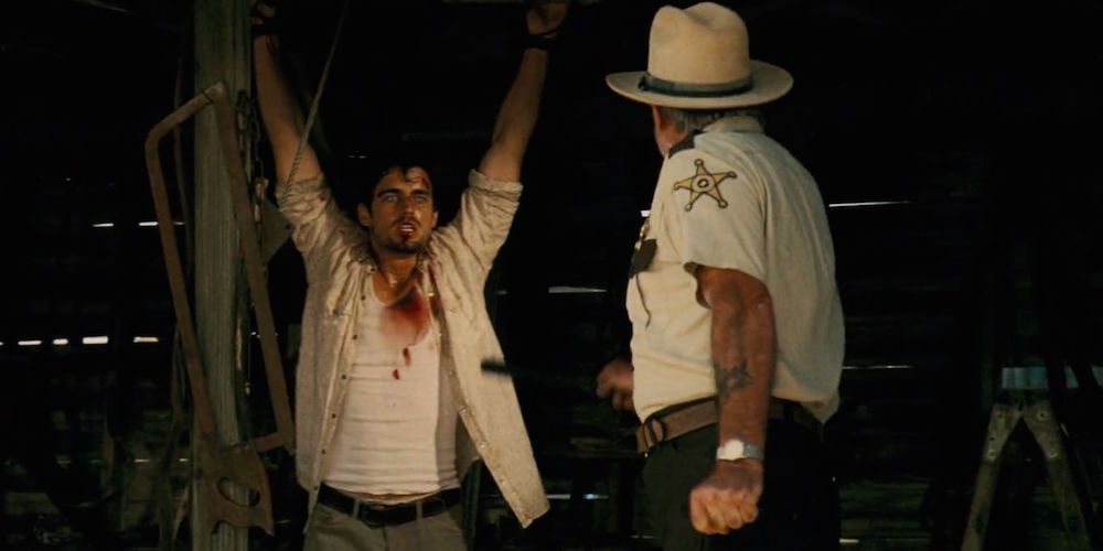 A man gets tortured by the sheriff in Texas Chainsaw Massacre: The Beginning