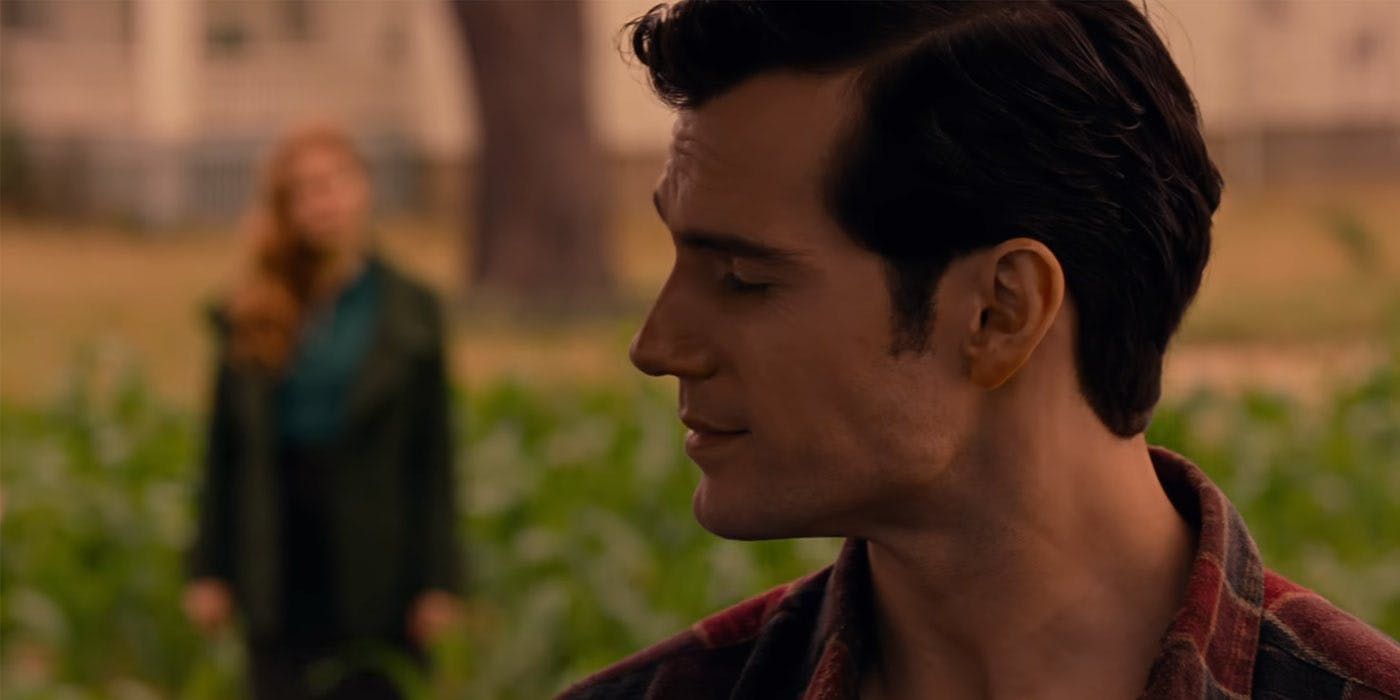 Henry Cavill as Clark Kent and Amy Adams as Lois Lane standing in a field in the Justice League trailer