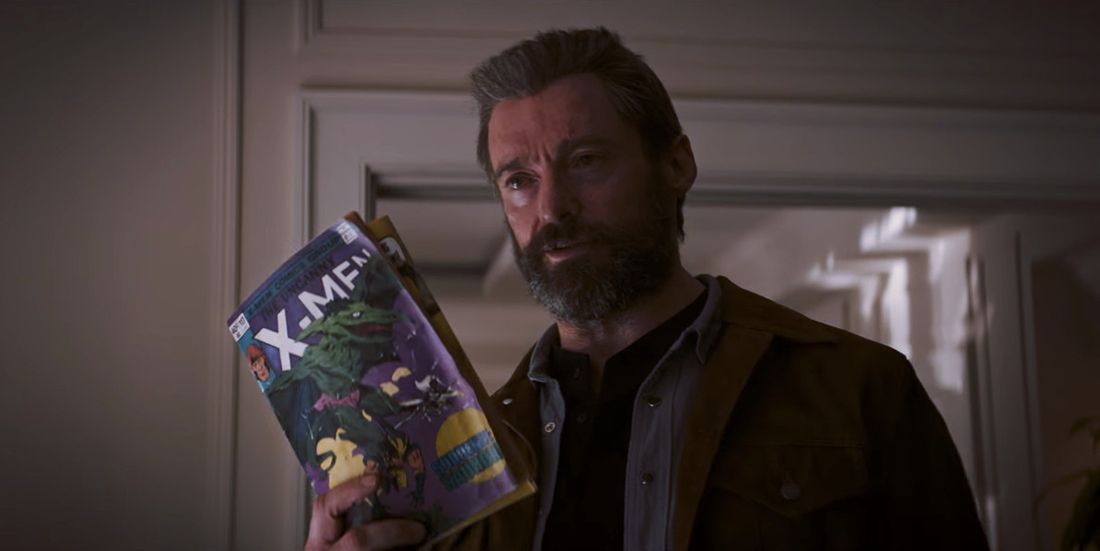 Logan Holding an X-Men Comic