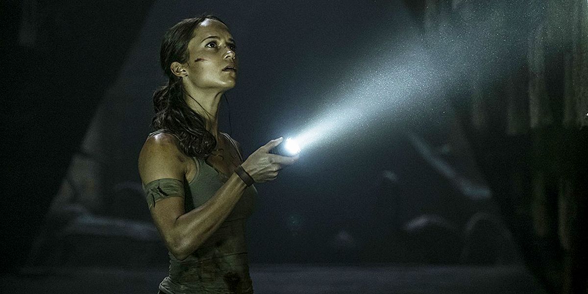 Lara Croft holding a flashlight upward in Tomb Raider