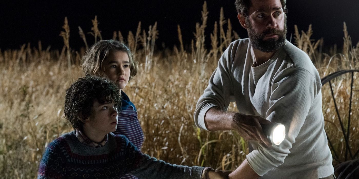 A family secretly hiding in a field in A Quiet Place