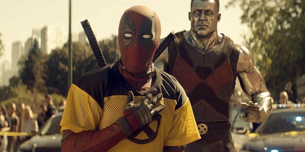 Deadpool clutches his chest while Colossus stands behind him in Deadpool 2