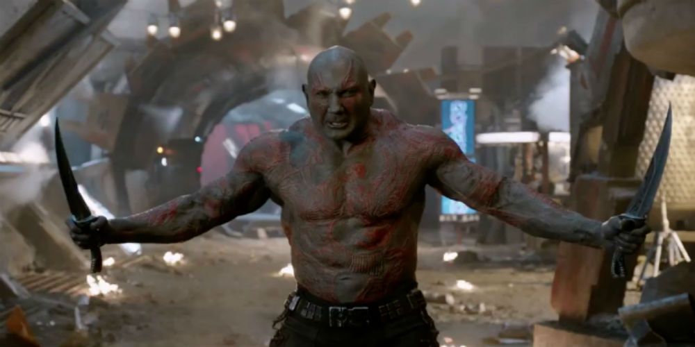 Drax (Dave Bautista) is in a battle stance holding two knives