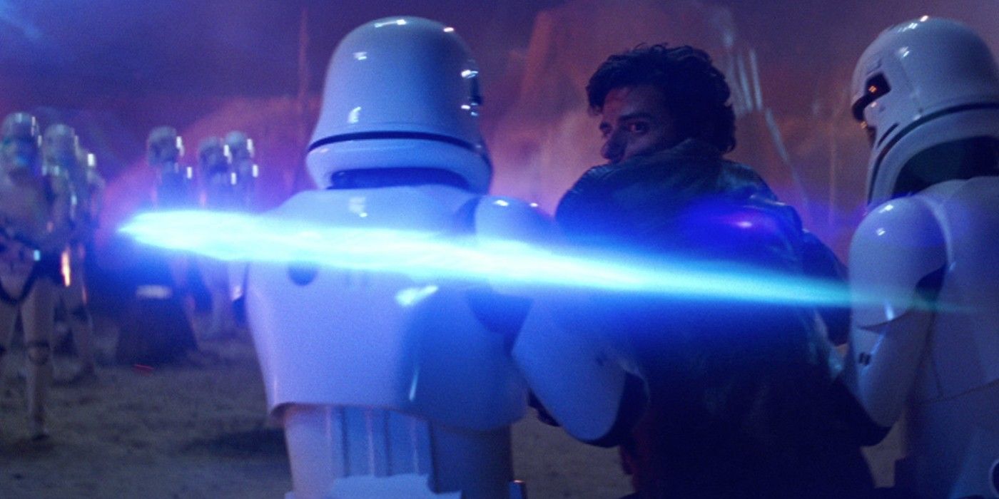 Poe Dameron is taken away by two stormtroopers as a blaster bolt is stopped in The Force Awakens.