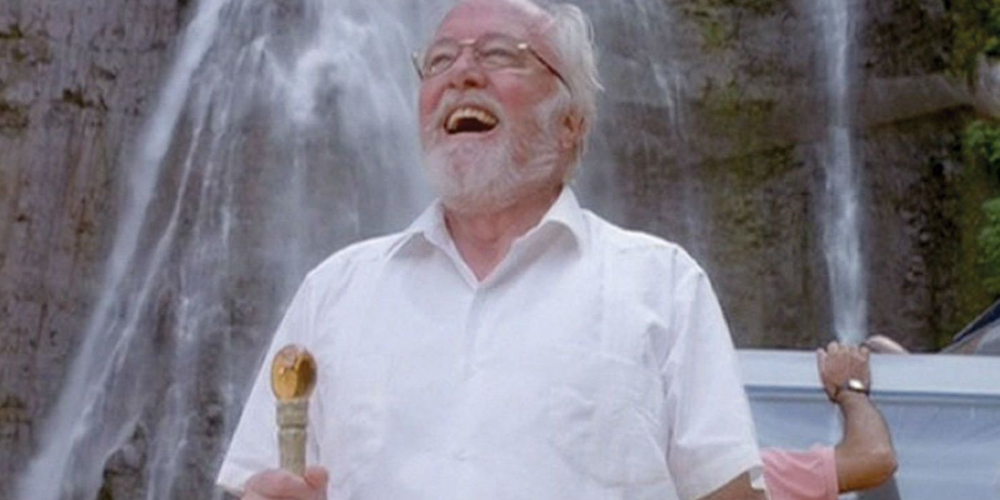 John Hammond holding the amber cane and smiling at his creation.