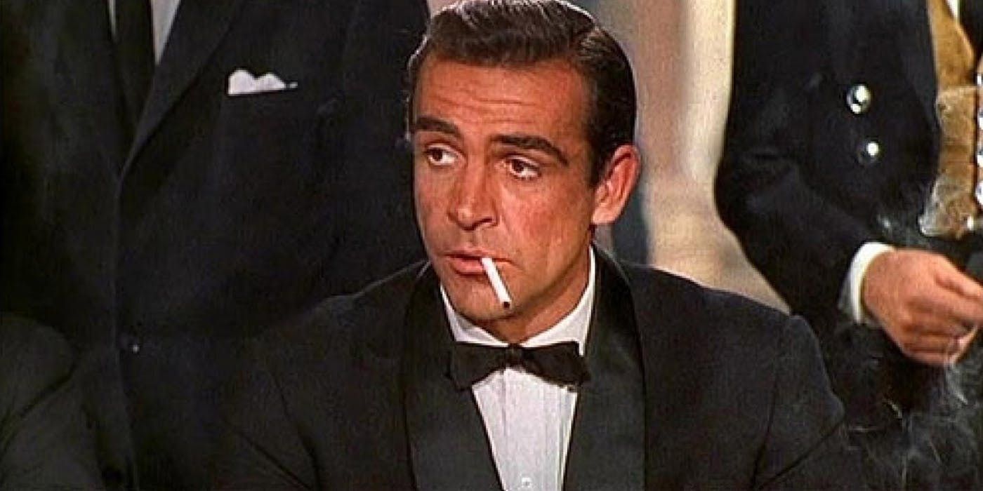 Sean Connery as James Bond smokes a cigarette in Dr. No.