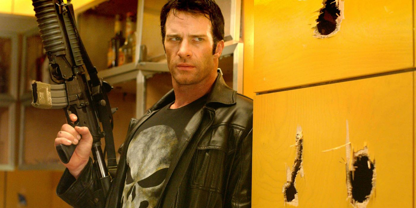 Thomas Jane as Frank Castle next to some large bullet holes in 2004's The Punisher.