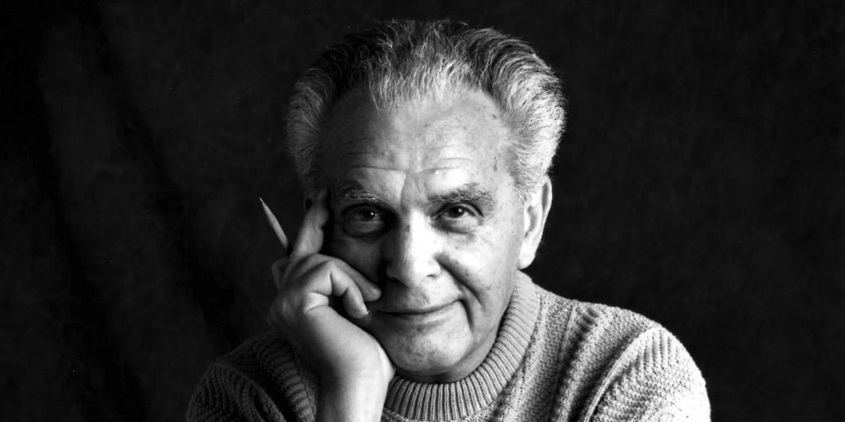 Jack Kirby smiling with a pencil in his hand