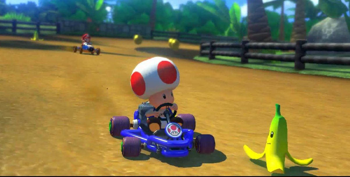 Toad driving a kart near a banana peel from Mario Kart series.