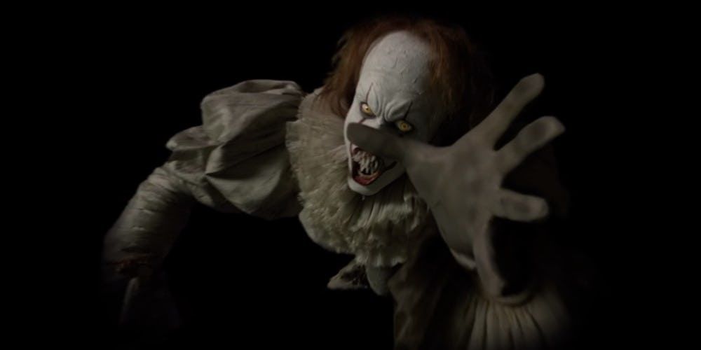 Pennywise reaching out to grab a kid