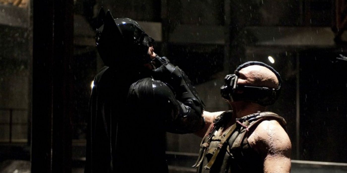 Bane lifting Batman off the ground with a choke hold