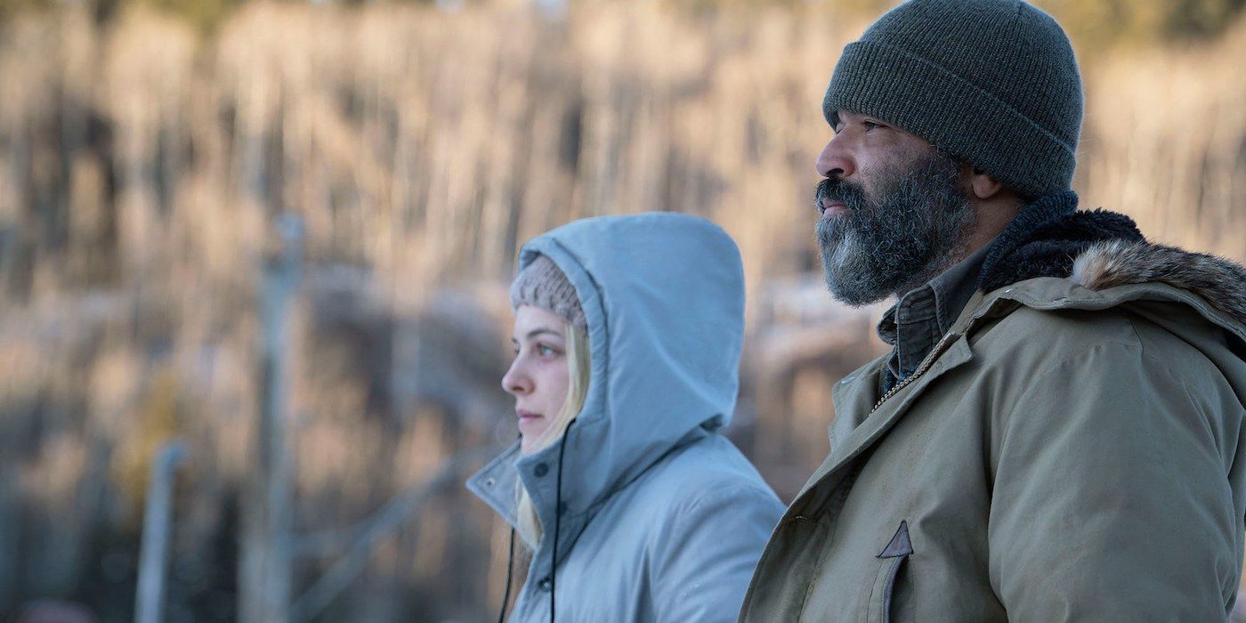 Hold the Dark's Russell and Medora walk side by side wearing hats and coats