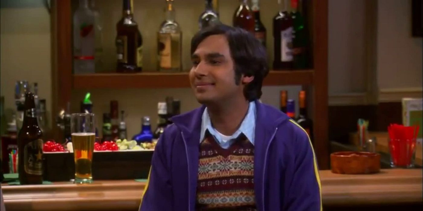 Raj sitting at a bar smiling in a scene from The Big Bang Theory.