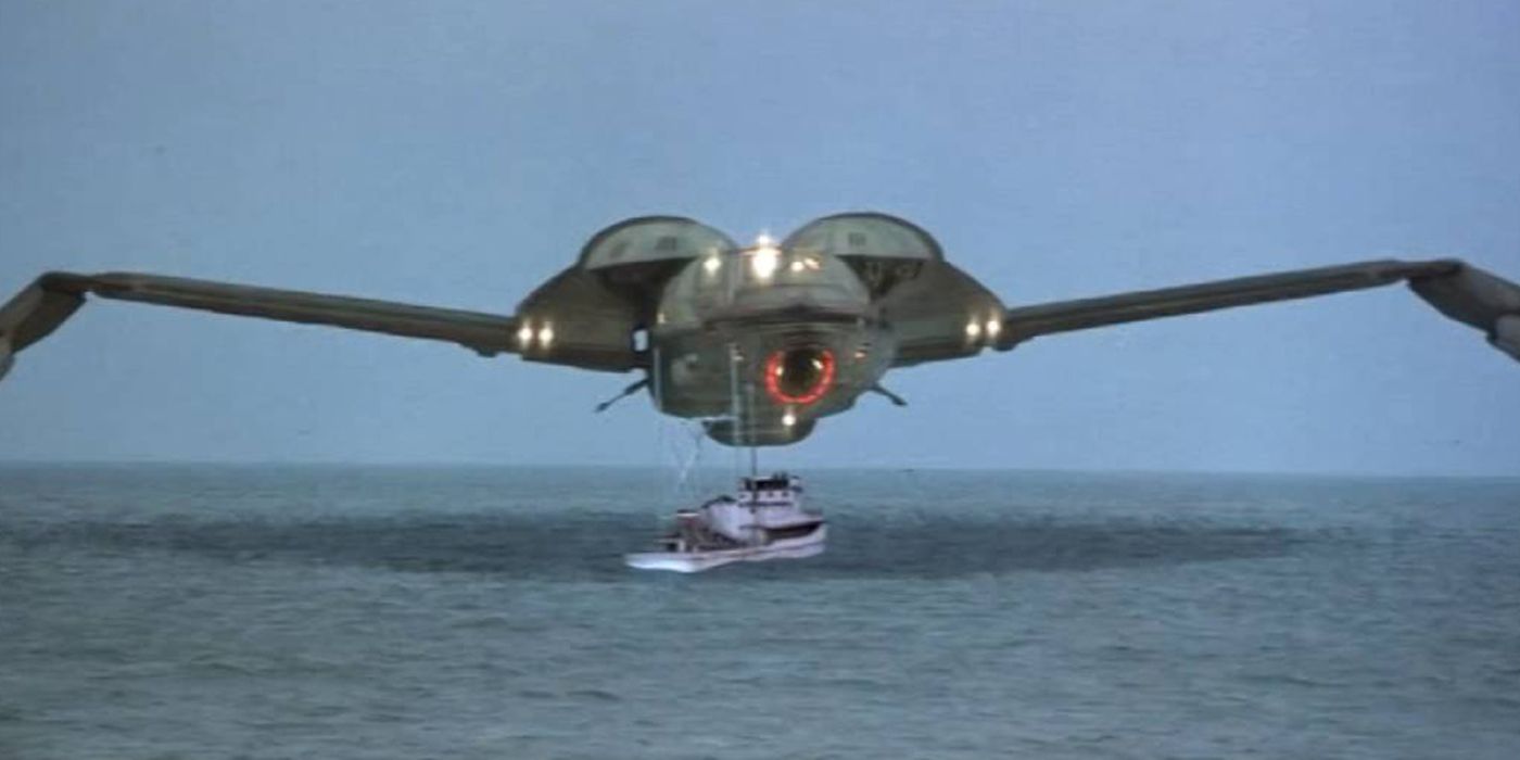The Bounty, a Klingon bird of prey, hovers over a ship in the ocean in Star Wars.