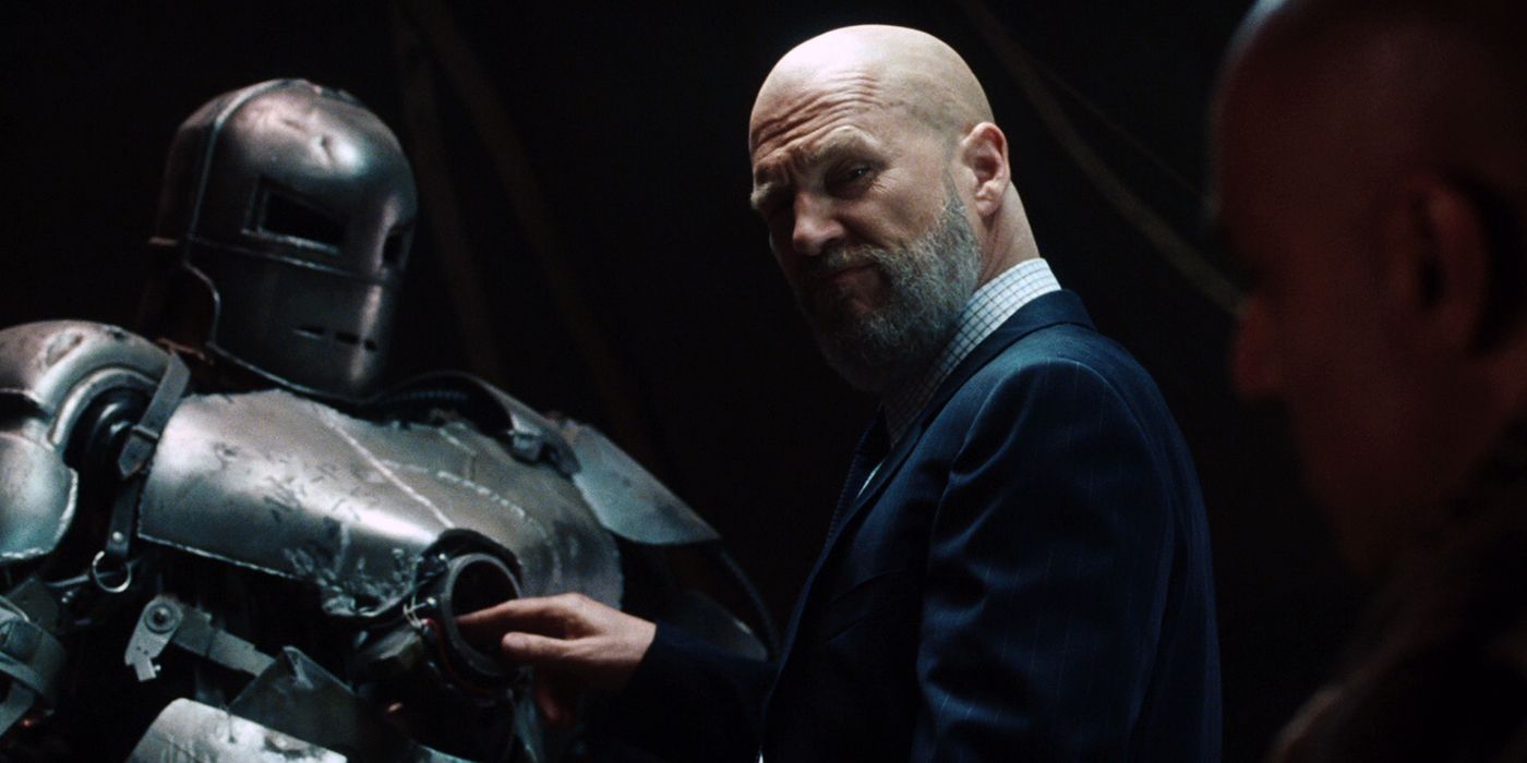 Obadiah Stane checks out an armored suit in the dark