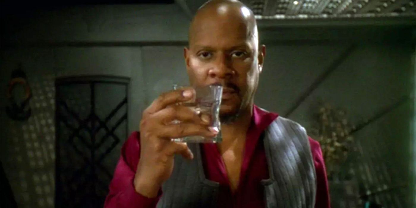 Sisko lifts a glass in Star Trek: DS9