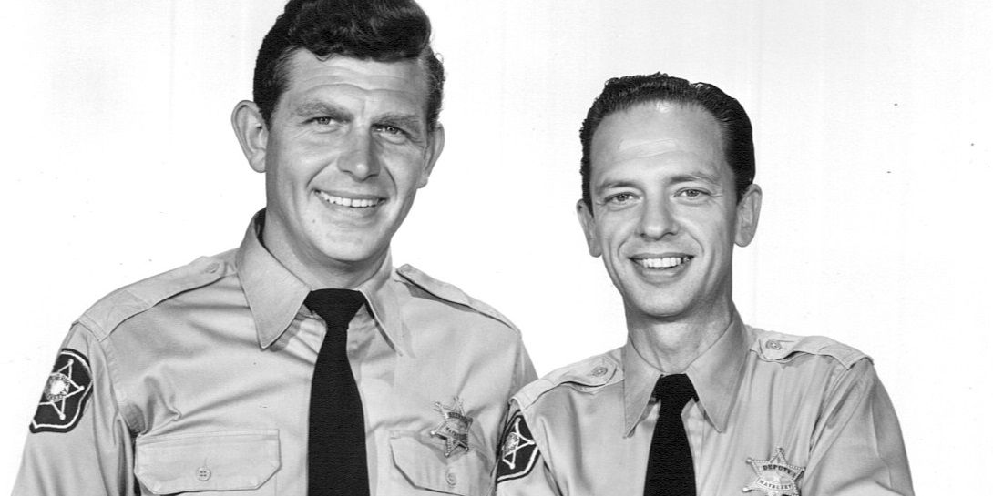 Andy and Barney smile together in a still from the Andy Griffith Show