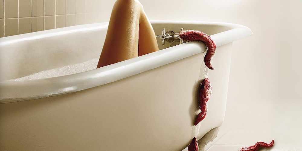 The monsters from Slither slither into a bathtub with a leg poking out of it