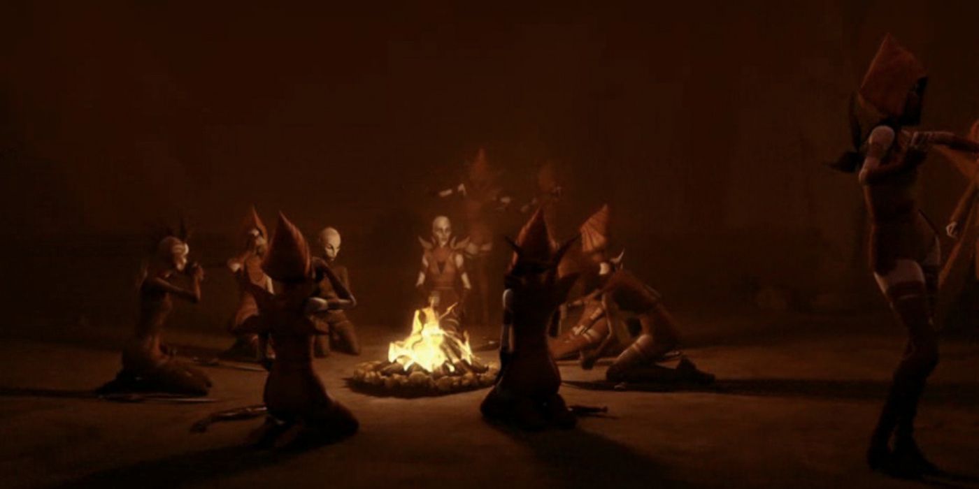 Ventress and Night Sisters sit around a fire on Dathomir